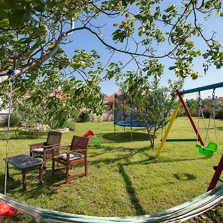 Modern Stone House With Flowers & Playground